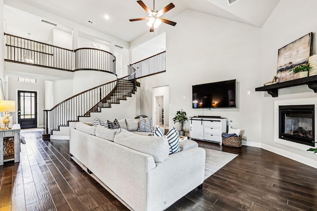 639 Cirrus Ln, Fate, TX 75087 - living room featuring high vaulted ceiling, stairs, dark wood-type flooring, ceiling fan, and baseboards