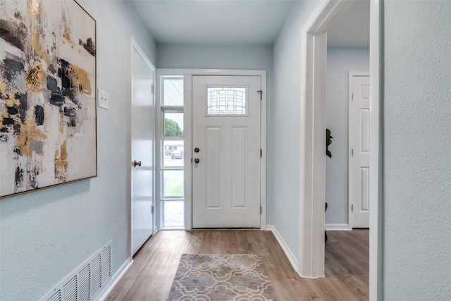 2335 San Paula Ave, Dallas, TX 75228 - foyer entrance with plenty of natural light, wood finished floors, baseboards, and a textured wall