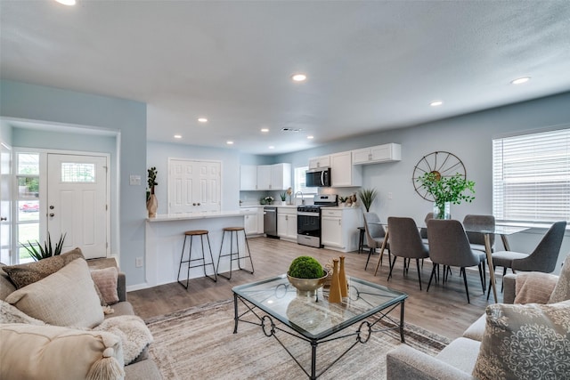 2335 San Paula Ave, Dallas, TX 75228 - living area featuring light wood-style flooring, recessed lighting, and baseboards