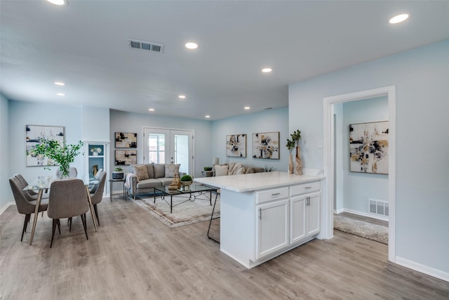 2335 San Paula Ave, Dallas, TX 75228 - kitchen featuring white cabinets, light wood-style flooring, light countertops, baseboards, and recessed lighting