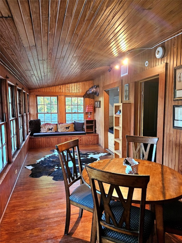 301 W Larissa St, Jacksonville, TX 75766 - dining area with wood walls, wooden ceiling, and wood finished floors