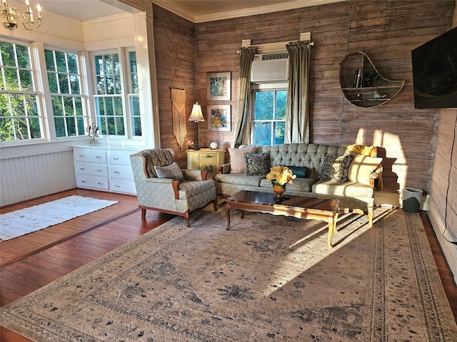 301 W Larissa St, Jacksonville, TX 75766 - living area with hardwood / wood-style flooring, crown molding, wood walls, a chandelier, and a wall mounted air conditioner