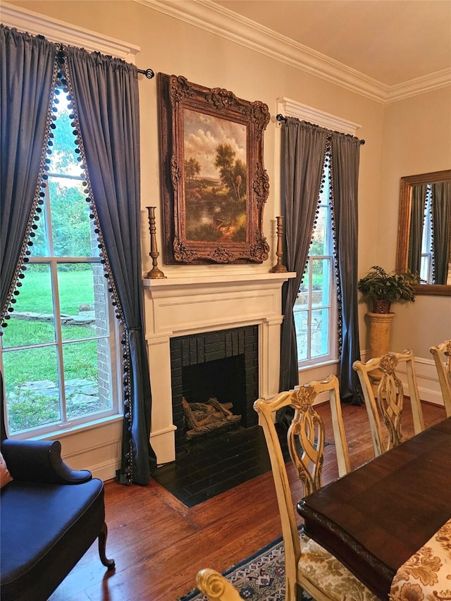 301 W Larissa St, Jacksonville, TX 75766 - sitting room with wood finished floors, crown molding, healthy amount of natural light, and a brick fireplace