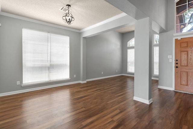 4504 Angelina Way, Fort Worth, TX 76137 - foyer with a textured ceiling, plenty of natural light, ornamental molding, dark wood-style flooring, and baseboards