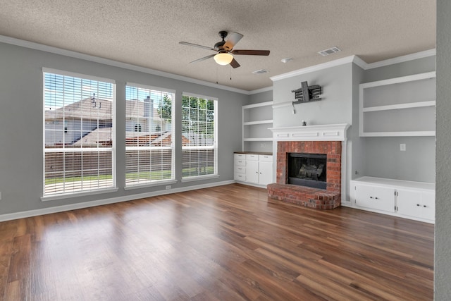 4504 Angelina Way, Fort Worth, TX 76137 - unfurnished living room with ceiling fan, a textured ceiling, crown molding, built in features, and a brick fireplace