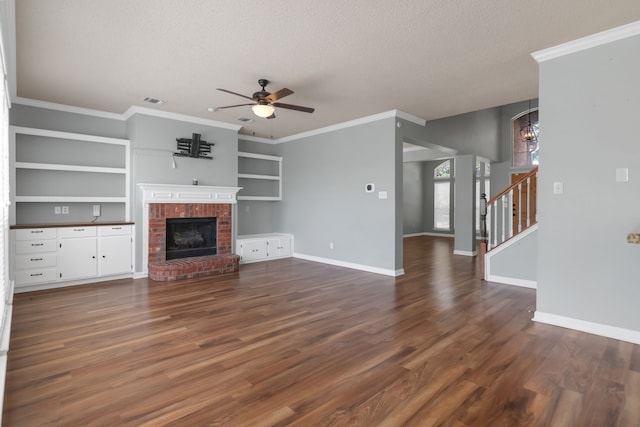 4504 Angelina Way, Fort Worth, TX 76137 - unfurnished living room featuring a textured ceiling, a ceiling fan, stairway, dark wood-style flooring, and a brick fireplace
