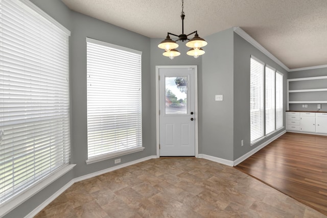 4504 Angelina Way, Fort Worth, TX 76137 - entrance foyer with a chandelier, a textured ceiling, and baseboards