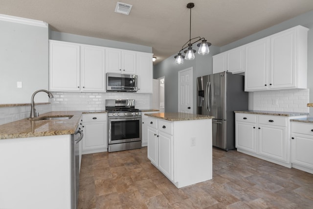 4504 Angelina Way, Fort Worth, TX 76137 - kitchen featuring appliances with stainless steel finishes, a sink, decorative backsplash, light stone counters, and white cabinets