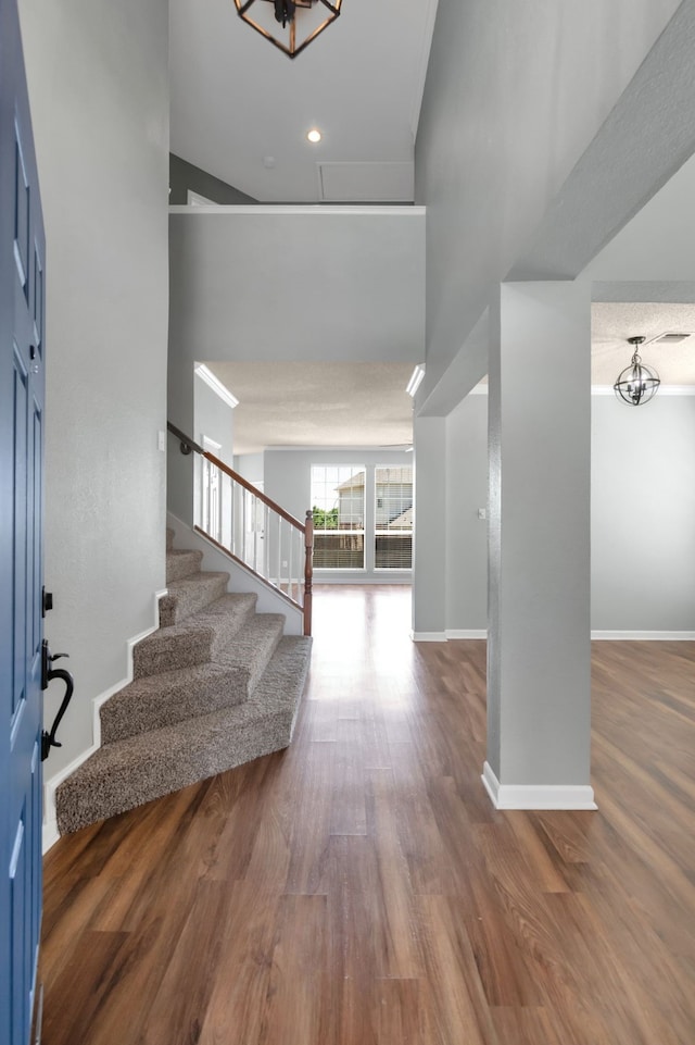 4504 Angelina Way, Fort Worth, TX 76137 - entrance foyer featuring a chandelier, stairs, wood finished floors, baseboards, and a towering ceiling