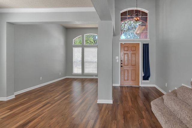 4504 Angelina Way, Fort Worth, TX 76137 - entryway with a chandelier, dark wood-type flooring, a textured ceiling, baseboards, and stairs