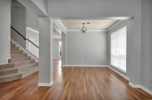4504 Angelina Way, Fort Worth, TX 76137 - spare room featuring ornamental molding, dark wood-type flooring, stairway, baseboards, and a chandelier