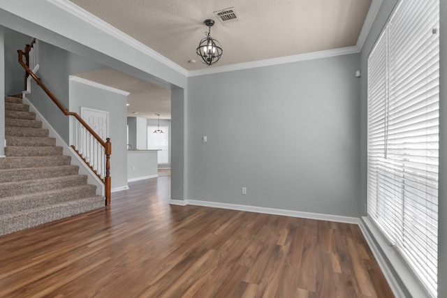 4504 Angelina Way, Fort Worth, TX 76137 - spare room featuring a chandelier, stairway, dark wood-style flooring, a textured ceiling, and crown molding