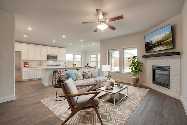 3750 Pinyon Pine Way, Venus, TX 76084 - living room with light wood-style flooring, ceiling fan, recessed lighting, baseboards, and a stone fireplace