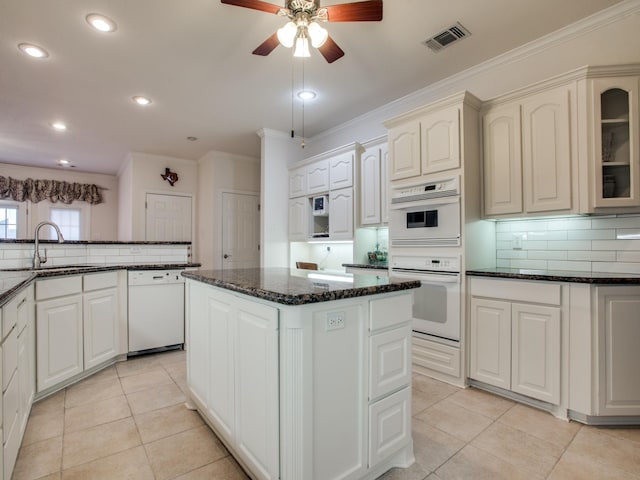503 Hillcrest Ln, Krum, TX 76249 - kitchen with white appliances, a sink, crown molding, tasteful backsplash, and a center island
