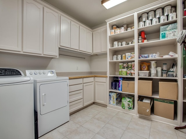 503 Hillcrest Ln, Krum, TX 76249 - laundry room with washing machine and clothes dryer, light tile patterned floors, and cabinet space