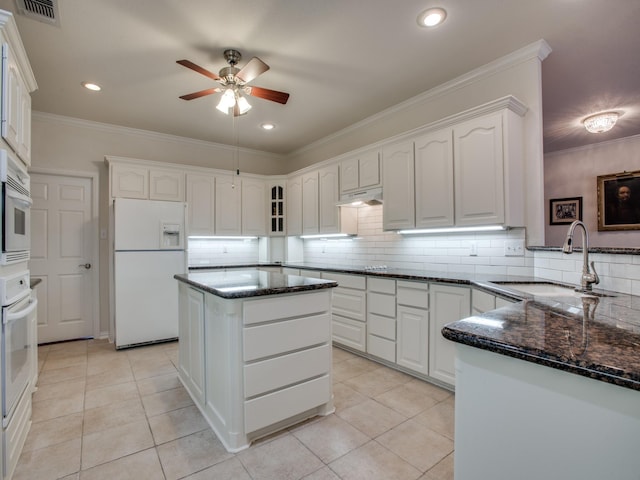 503 Hillcrest Ln, Krum, TX 76249 - kitchen with white appliances, a sink, under cabinet range hood, ceiling fan, and dark stone counters