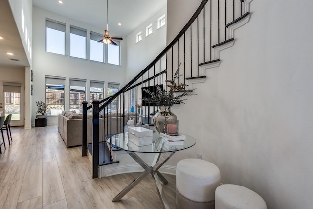3229 Creek Meadow Dr, Anna, TX 75409 - dining area with light wood-style floors, ceiling fan, stairs, a towering ceiling, and recessed lighting