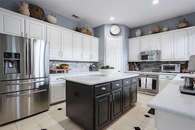 1217 Waterford Way, Allen, TX 75013 - kitchen with appliances with stainless steel finishes, white cabinets, dark cabinets, tasteful backsplash, and light tile patterned floors