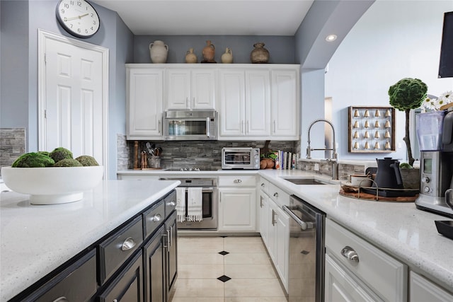 1217 Waterford Way, Allen, TX 75013 - kitchen featuring stainless steel appliances, a sink, white cabinetry, tasteful backsplash, and recessed lighting