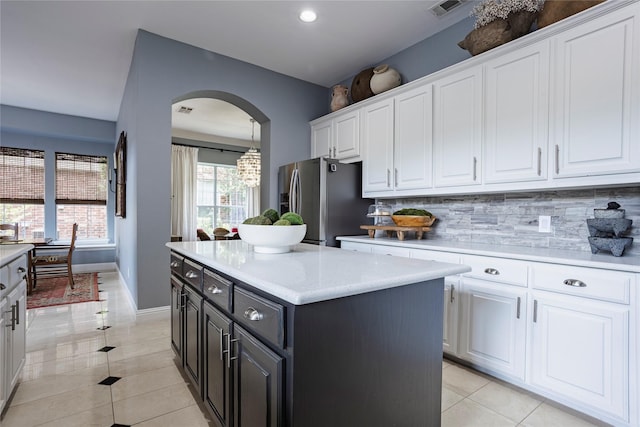 1217 Waterford Way, Allen, TX 75013 - kitchen with stainless steel refrigerator with ice dispenser, white cabinetry, arched walkways, light tile patterned flooring, and recessed lighting