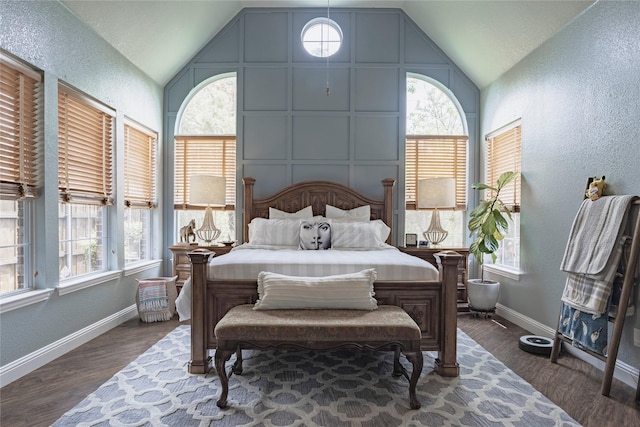 1217 Waterford Way, Allen, TX 75013 - bedroom with vaulted ceiling, multiple windows, baseboards, a textured wall, and dark wood-style floors