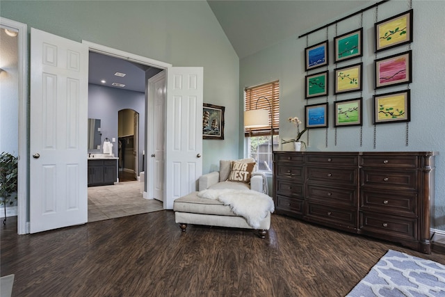 1217 Waterford Way, Allen, TX 75013 - living area featuring wood finished floors, arched walkways, high vaulted ceiling, and baseboards
