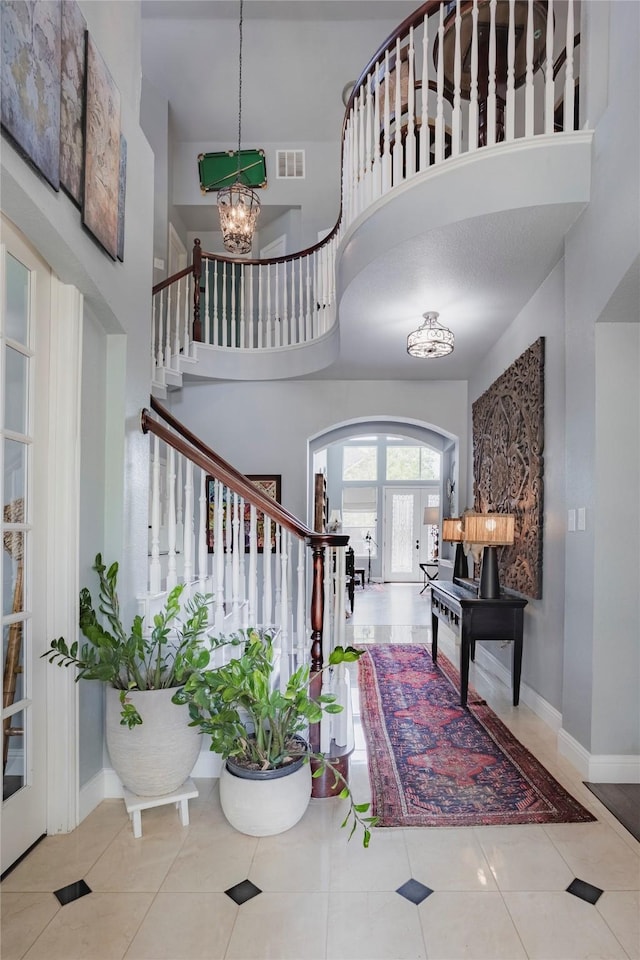 1217 Waterford Way, Allen, TX 75013 - tiled foyer with stairway, a chandelier, a towering ceiling, baseboards, and arched walkways