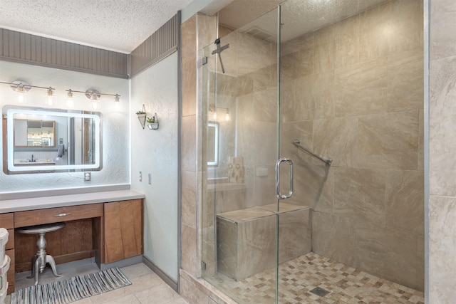 5295 Ganzer Rd W, Krum, TX 76249 - bathroom featuring a stall shower, tile patterned flooring, a textured ceiling, toilet, and vanity
