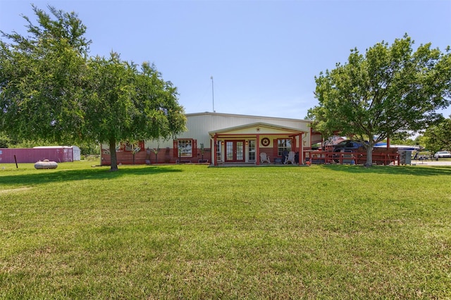 5295 Ganzer Rd W, Krum, TX 76249 - rear view of house with french doors and a yard