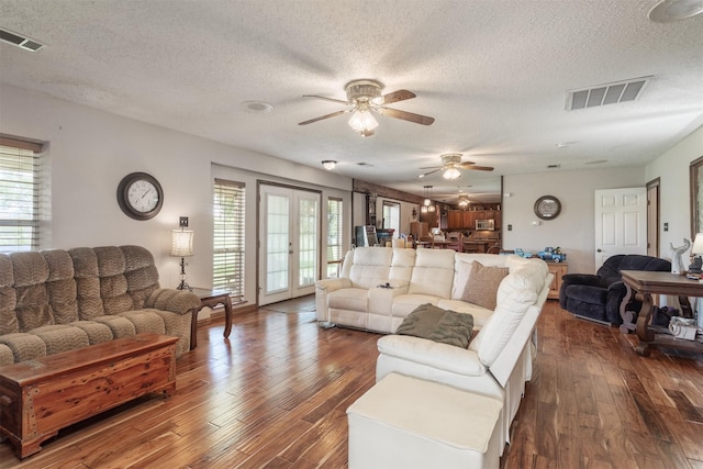 5295 Ganzer Rd W, Krum, TX 76249 - living area with a textured ceiling, a ceiling fan, and dark wood-type flooring
