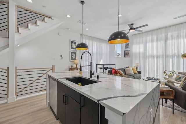 2102 N Prairie Ave Unit 105, Dallas, TX 75204 - kitchen featuring a sink, a ceiling fan, open floor plan, light wood-type flooring, and recessed lighting