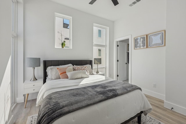 2102 N Prairie Ave Unit 105, Dallas, TX 75204 - bedroom with light wood-type flooring, baseboards, and a ceiling fan