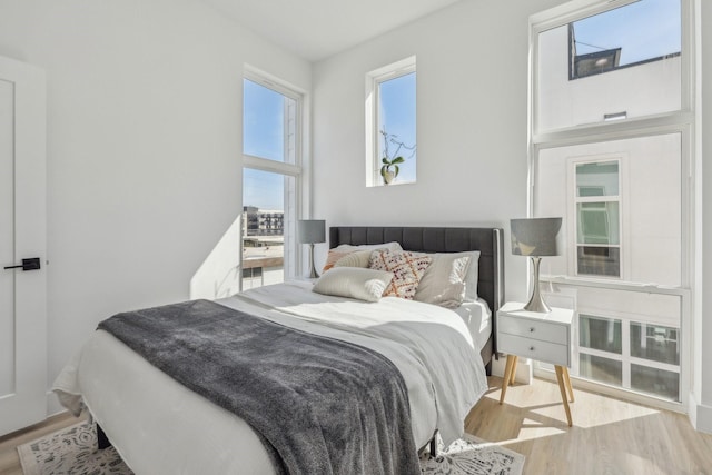 2102 N Prairie Ave Unit 105, Dallas, TX 75204 - bedroom featuring wood finished floors