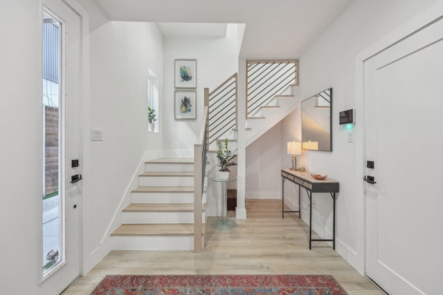 2102 N Prairie Ave Unit 105, Dallas, TX 75204 - foyer entrance with stairs, wood finished floors, and baseboards