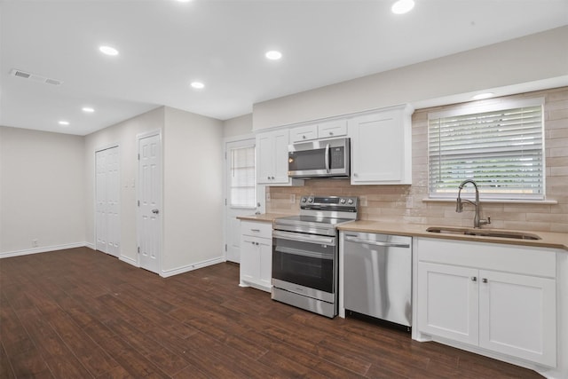 1201 Crockett St, Garland, TX 75040 - kitchen with stainless steel appliances, a sink, tasteful backsplash, light countertops, and recessed lighting