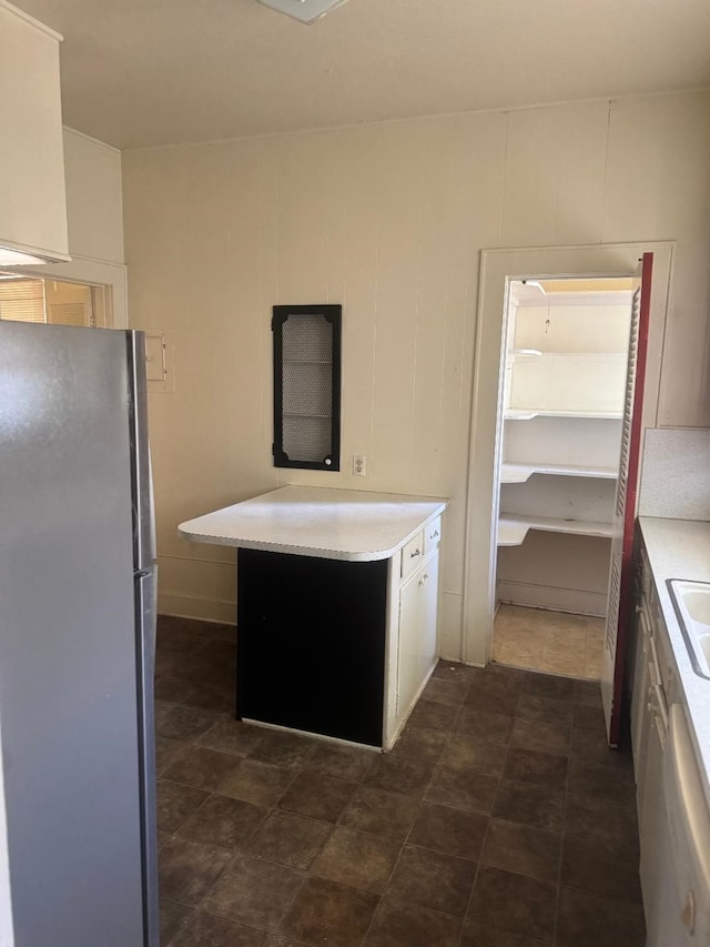 605 Merrick St, Shreveport, LA 71104 - kitchen with freestanding refrigerator, light countertops, a sink, and dishwashing machine