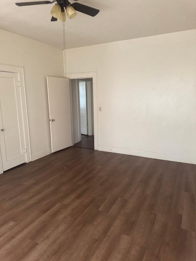 605 Merrick St, Shreveport, LA 71104 - empty room with a ceiling fan, dark wood finished floors, and baseboards