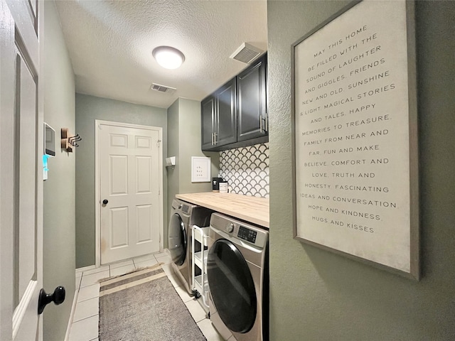 5805 Bridal Trl, Fort Worth, TX 76179 - laundry room featuring cabinet space, separate washer and dryer, light tile patterned floors, and a textured ceiling