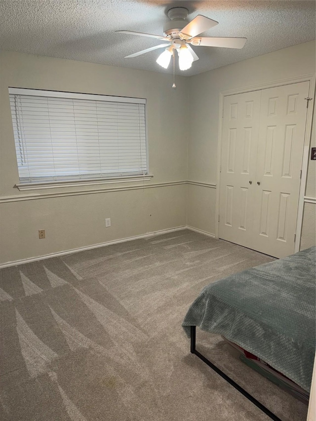 4809 Westhaven Rd, Arlington, TX 76017 - unfurnished bedroom with carpet flooring, a textured ceiling, ceiling fan, baseboards, and a closet