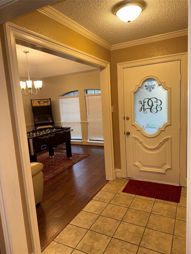 4809 Westhaven Rd, Arlington, TX 76017 - entrance foyer featuring a chandelier, a textured ceiling, and wood finished floors