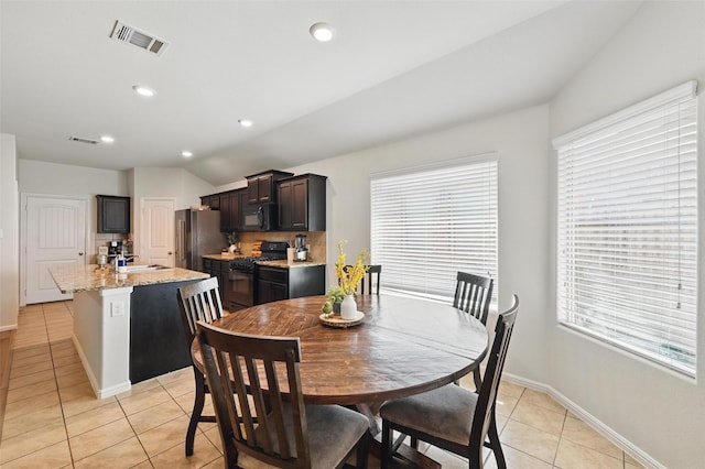 737 Walls Blvd, Crowley, TX 76036 - dining area with light tile patterned floors, plenty of natural light, baseboards, vaulted ceiling, and recessed lighting