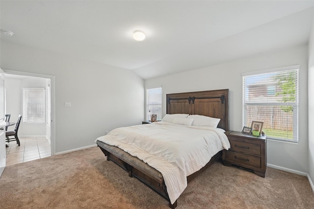 737 Walls Blvd, Crowley, TX 76036 - bedroom with light colored carpet, lofted ceiling, baseboards, and light tile patterned floors