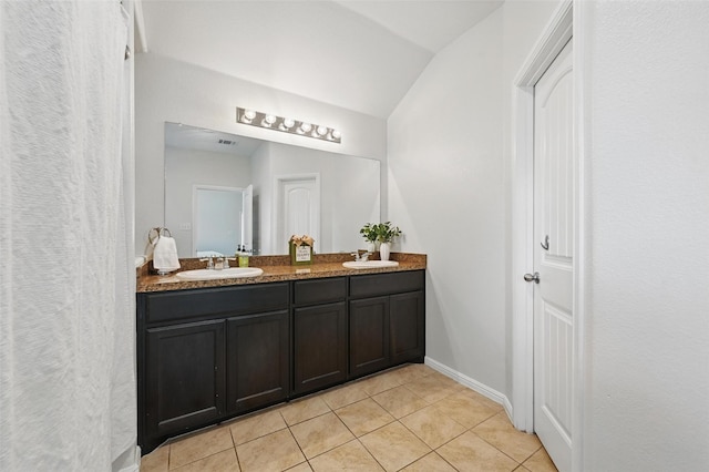 737 Walls Blvd, Crowley, TX 76036 - full bath featuring tile patterned floors, double vanity, baseboards, and vaulted ceiling