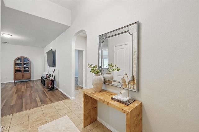 737 Walls Blvd, Crowley, TX 76036 - hallway with arched walkways, tile patterned flooring, baseboards, and a desk