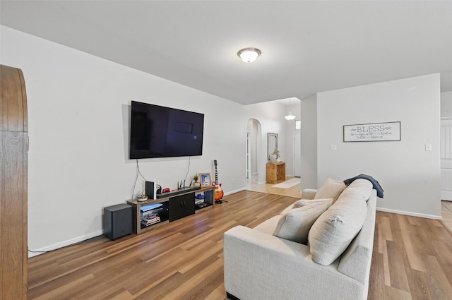 737 Walls Blvd, Crowley, TX 76036 - living room with arched walkways, wood finished floors, and baseboards