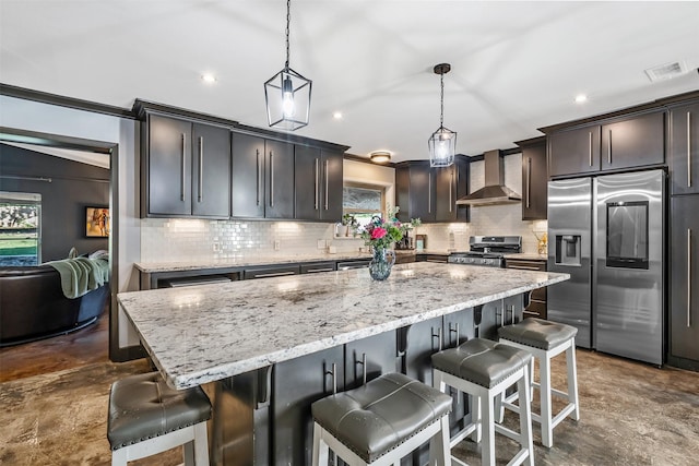 3020 Meadowlark, Tyler, TX 75701 - kitchen featuring appliances with stainless steel finishes, wall chimney range hood, backsplash, a center island, and recessed lighting