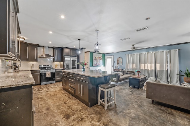 3020 Meadowlark, Tyler, TX 75701 - kitchen with appliances with stainless steel finishes, wall chimney range hood, open floor plan, tasteful backsplash, and a kitchen breakfast bar