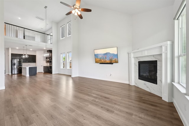 6322 Farndon Dr, Celina, TX 76227 - unfurnished living room featuring a high ceiling, a fireplace, dark wood-style flooring, a ceiling fan, and recessed lighting