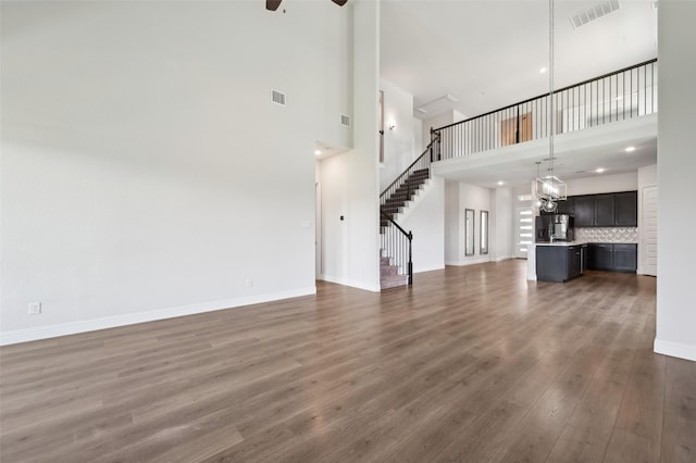 6322 Farndon Dr, Celina, TX 76227 - unfurnished living room with a high ceiling, wood finished floors, stairs, and ceiling fan