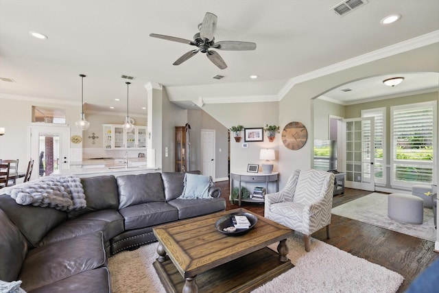 528 Layton Dr, Coppell, TX 75019 - living room featuring a ceiling fan, dark wood finished floors, crown molding, arched walkways, and recessed lighting